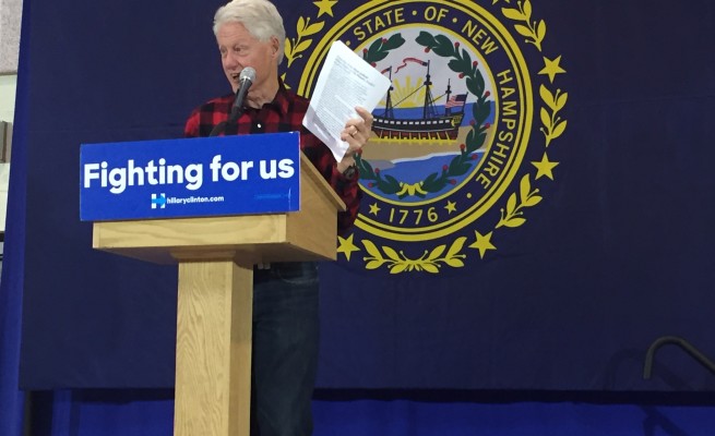 President Clinton shows the audience a copy of an email he received specifying why